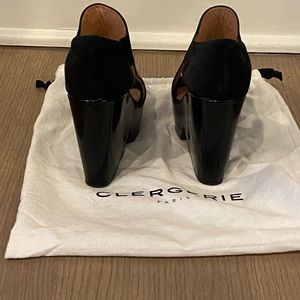 Robert Clergerie’s platform mules are crafted of black leather with open toe